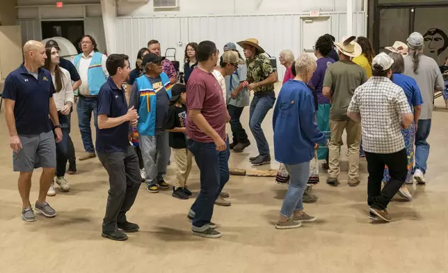 Shawnee Tribe members and guests from Firaxis participate in a stomp dance on Friday, September 20, 2024 in Miami, Okla.. (AP Photo/Nick Oxford)