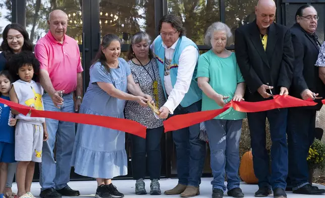 Members of the Shawnee Tribe cut the ribbon at the Shawnee Language Center on Friday, September 20, 2024 in Miami, Okla.. (AP Photo/Nick Oxford)