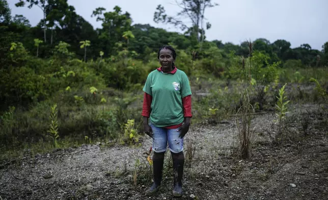 Dioselina Palacios, part of Asociacion Nuestra Casa Comun, or Our Community House Association, poses for a photo while reforesting an area near Paimado, Colombia, Tuesday, Sept. 24, 2024. (AP Photo/Ivan Valencia)