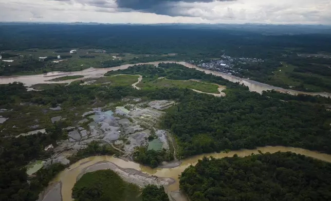 Visible deforestation from illegal mining sits along rivers near Paimado, Colombia, Tuesday, Sept. 24, 2024. (AP Photo/Ivan Valencia)