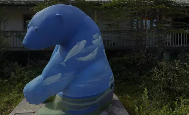 A polar bear statue with painted beluga whales sits outside a gift shop, Tuesday, Aug. 6, 2024, in Churchill, Manitoba. (AP Photo/Joshua A. Bickel)