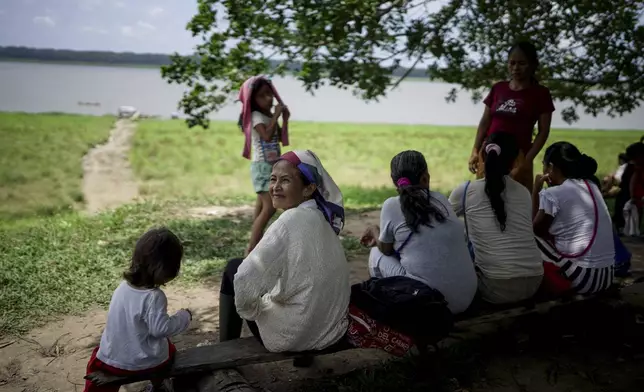 People from the Tikuna Indigenous community wait to receive aid from a nonprofit amid a drought on Amazon River in Loma Linda, near Leticia, Colombia, Sunday, Oct. 20, 2024. (AP Photo/Ivan Valencia)