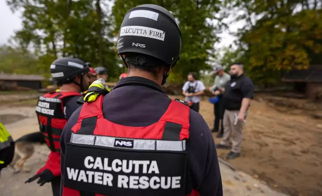 Search and Rescue members take a briefing in the aftermath of Hurricane Helene, Tuesday, Oct. 1, 2024, in Swannanoa, N.C. (AP Photo/Mike Stewart)