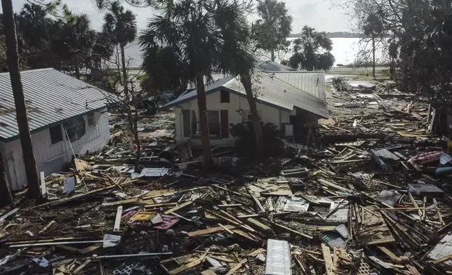 FILE - Debris surrounds the Faraway Inn Cottages and Motel in the aftermath of Hurricane Helene, in Cedar Key, Fla., Sept. 27, 2024. (AP Photo/Stephen Smith, File)