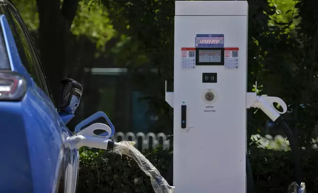 FILE - A Chinese electric vehicle charges in Beijing, Monday, June 24, 2024. (AP Photo/Andy Wong, File)