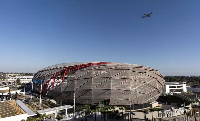 A commercial jet passes by the Intuit Dome, the new home of the Los Angeles Clippers, Monday, Oct. 14, 2024, in Inglewood, Calif.(AP Photo/Jae C. Hong)