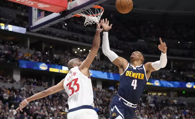 Los Angeles Clippers forward Nicolas Batum (33) blocks a shot against Denver Nuggets guard Russell Westbrook (4) during the first half of an NBA basketball game Saturday, Oct. 26, 2024, in Denver. (AP Photo/Jack Dempsey)