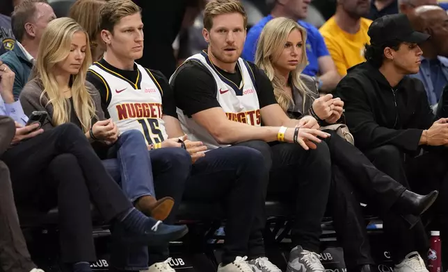 Colorado Avalanche players Nathan MacKinnon, left, and Gabriel Landeskog attend the first half of an NBA basketball game between the Denver Nuggets and the Los Angeles Clippers, Saturday, Oct. 26, 2024, in Denver. (AP Photo/Jack Dempsey)