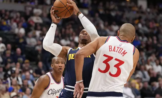 Los Angeles Clippers forward Nicolas Batum (33) fouls Denver Nuggets guard Russell Westbrook (4) during the first half of an NBA basketball game Saturday, Oct. 26, 2024, in Denver. (AP Photo/Jack Dempsey)