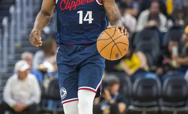Los Angeles Clippers guard Terance Mann (14) dribbles during the second half of an NBA basketball game against the Golden State Warriors in San Francisco, Sunday, Oct. 27, 2024. (AP Photo/Nic Coury)