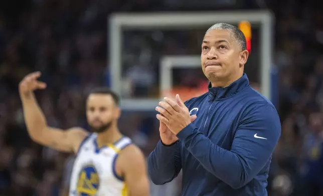 Los Angeles Clippers head coach Tyronn Lue, right, celebrates after a basket during the first half of an NBA basketball game against the Golden State Warriors in San Francisco, Sunday, Oct. 27, 2024. (AP Photo/Nic Coury)