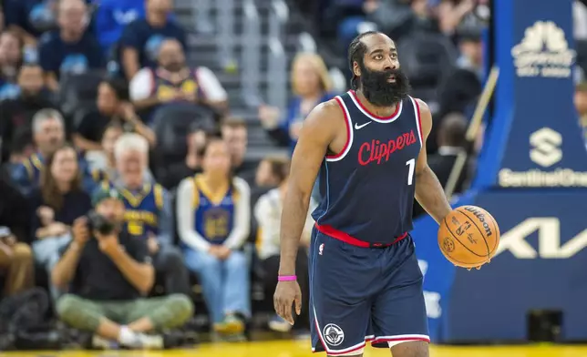 Los Angeles Clippers guard James Harden (1) dribbles during the second half of an NBA basketball game against the Golden State Warriors in San Francisco, Sunday, Oct. 27, 2024. (AP Photo/Nic Coury)