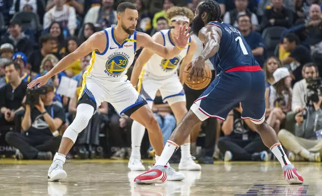 Golden State Warriors guard Stephen Curry (30) tries to block Los Angeles Clippers guard James Harden (1) during the first half of an NBA basketball game in San Francisco, Sunday, Oct. 27, 2024. (AP Photo/Nic Coury)