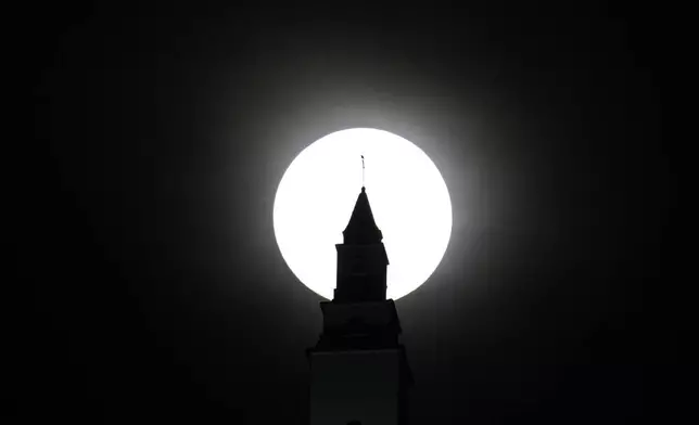 The supermoon looms over a basilica in Bogota, Colombia, Wednesday, Oct. 16, 2024. (AP Photo/Fernando Vergara)