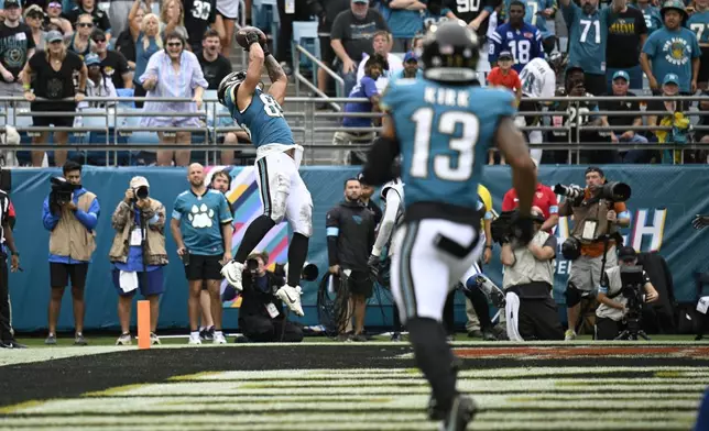 Jacksonville Jaguars tight end Brenton Strange (85) makes a touchdown catch during the second half of an NFL football game against the Indianapolis Colts, Sunday, Oct. 6, 2024, in Jacksonville, Fla. (AP Photo/Phelan M. Ebenhack)