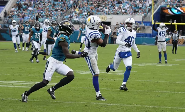 Indianapolis Colts' Nick Cross (20) intercepts a pass intended for Jacksonville Jaguars' Brian Thomas Jr. during the second half of an NFL football game, Sunday, Oct. 6, 2024, in Jacksonville, Fla. (AP Photo/John Raoux)