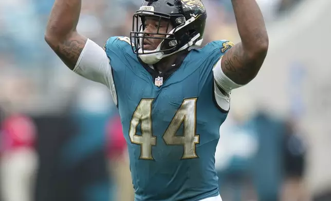 Jacksonville Jaguars' Travon Walker reacts during the second half of an NFL football game against the Indianapolis Colts, Sunday, Oct. 6, 2024, in Jacksonville, Fla. (AP Photo/John Raoux)