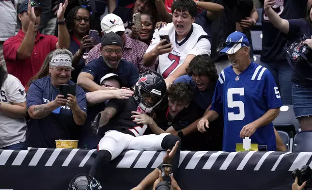 Houston Texans wide receiver Tank Dell (3) celebrates with fans after catching a 7-yard touchdown pass during the first half of an NFL football game against the Indianapolis Colts, Sunday, Oct. 27, 2024, in Houston. (AP Photo/Eric Christian Smith)