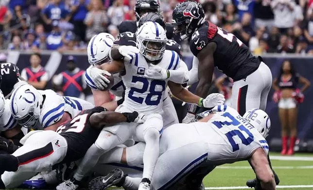 Indianapolis Colts running back Jonathan Taylor (28) scores on a 1-yard touchdown run during the second half of an NFL football game against the Houston Texans, Sunday, Oct. 27, 2024, in Houston. (AP Photo/Eric Christian Smith)