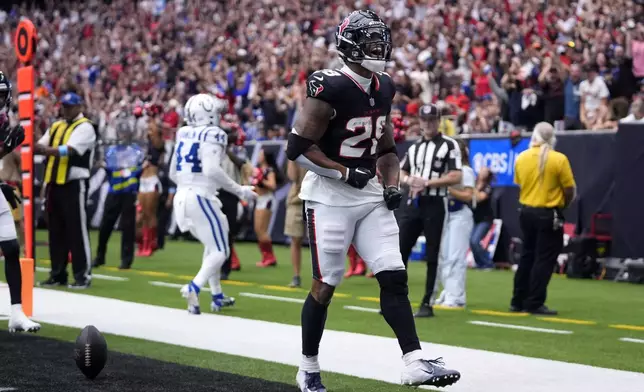 Houston Texans running back Joe Mixon (28) celebrates after a 14-yard touchdown run during the first half of an NFL football game against the Indianapolis Colts, Sunday, Oct. 27, 2024, in Houston. (AP Photo/Tony Gutierrez)