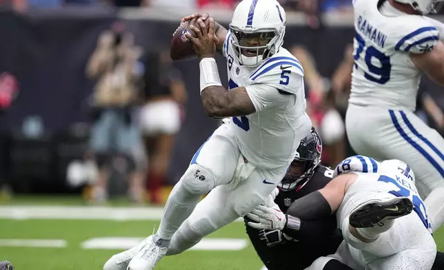 Indianapolis Colts quarterback Anthony Richardson (5) is sacked during the first half of an NFL football game against the Houston Texans, Sunday, Oct. 27, 2024, in Houston. (AP Photo/Tony Gutierrez)