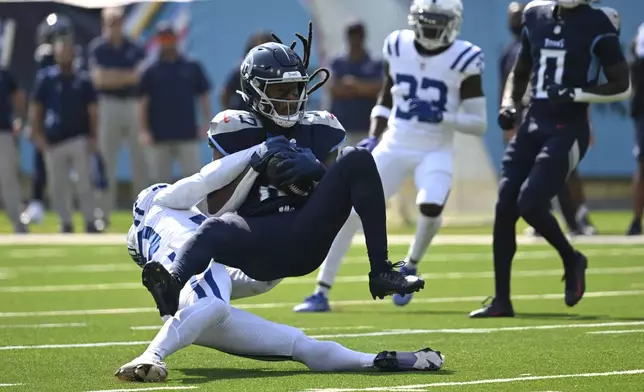 Tennessee Titans' DeAndre Hopkins (10) makes a catch against Indianapolis Colts' Jaylon Jones (40) during the first half of an NFL football game, Sunday, Oct. 13, 2024, in Nashville, Tenn. (AP Photo/John Amis)