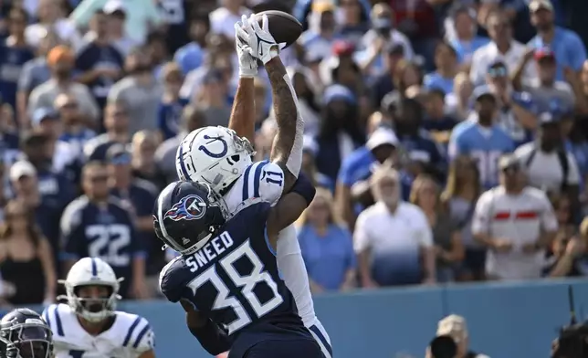 Indianapolis Colts wide receiver Michael Pittman Jr. (11) makes a touchdown catch against Tennessee Titans' L'Jarius Sneed (38) during the second half of an NFL football game, Sunday, Oct. 13, 2024, in Nashville, Tenn. (AP Photo/John Amis)