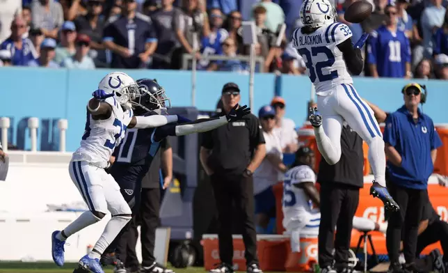 Indianapolis Colts safety Julian Blackmon (32) makes an interception during the second half of an NFL football game against the Tennessee Titans, Sunday, Oct. 13, 2024, in Nashville, Tenn. (AP Photo/George Walker IV)