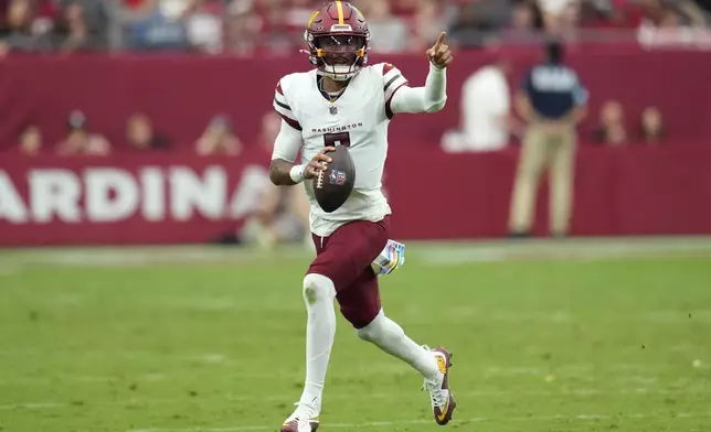 Washington Commanders quarterback Jayden Daniels (5) scrambles against the Arizona Cardinals during the first half of an NFL football game, Sunday, Sept. 29, 2024, in Glendale, Ariz. (AP Photo/Ross D. Franklin)