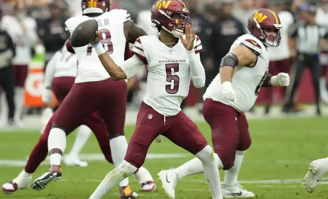 Washington Commanders quarterback Jayden Daniels (5) throws against the Arizona Cardinals during the first half of an NFL football game, Sunday, Sept. 29, 2024, in Glendale, Ariz. (AP Photo/Ross D. Franklin)