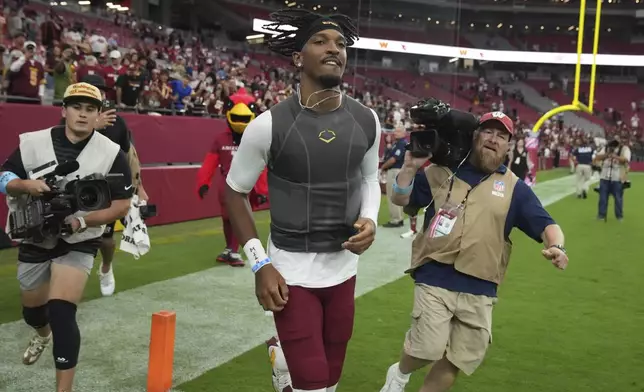 Washington Commanders quarterback Jayden Daniels leaves the field after an NFL football game against the Arizona Cardinals, Sunday, Sept. 29, 2024, in Glendale, Ariz. (AP Photo/Rick Scuteri)