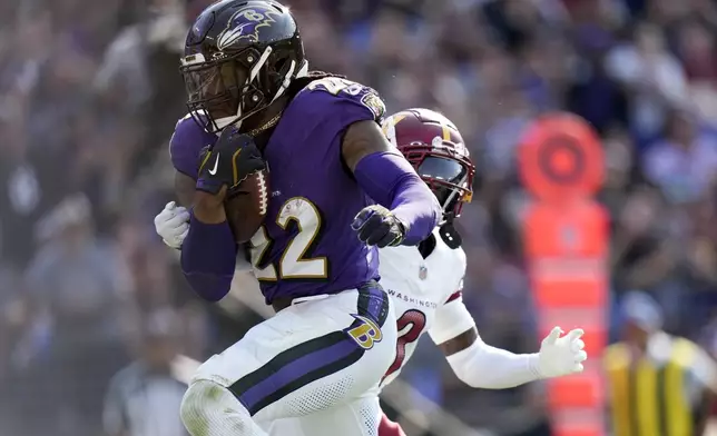 Baltimore Ravens running back Derrick Henry (22) scores on a touchdown run during the second half of an NFL football game against the Washington Commanders Sunday, Oct. 13, 2024, in Baltimore. (AP Photo/Stephanie Scarbrough)