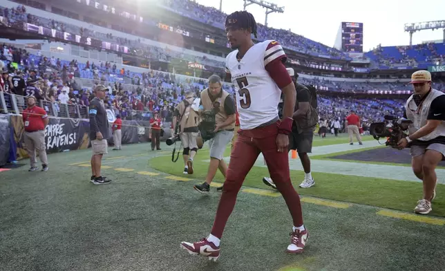 Washington Commanders quarterback Jayden Daniels walks off the field following an NFL football game against the Baltimore Ravens Sunday, Oct. 13, 2024, in Baltimore. The Ravens won 30-23. (AP Photo/Stephanie Scarbrough)