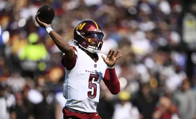 Washington Commanders quarterback Jayden Daniels throws during the first half of an NFL football game against the Baltimore Ravens Sunday, Oct. 13, 2024, in Baltimore. (AP Photo/Nick Wass)