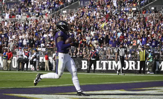 Baltimore Ravens running back Derrick Henry (22) scores on a 7-yard run during the second half of an NFL football game against the Washington Commanders Sunday, Oct. 13, 2024, in Baltimore. (AP Photo/Nick Wass)