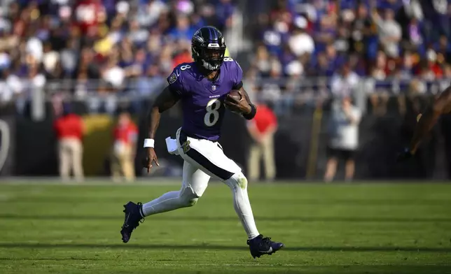 Baltimore Ravens quarterback Lamar Jackson scrambles during the second half of an NFL football game against the Washington Commanders Sunday, Oct. 13, 2024, in Baltimore. (AP Photo/Nick Wass)