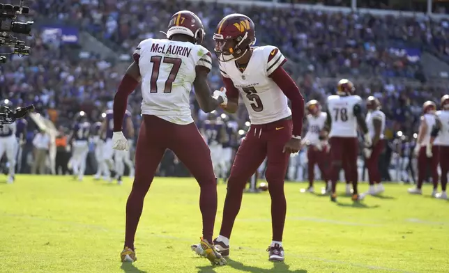 Washington Commanders wide receiver Terry McLaurin (17) celebrates after catching a 6-yard touchdown pass from quarterback Jayden Daniels (5) during the second half of an NFL football game against the Baltimore Ravens Sunday, Oct. 13, 2024, in Baltimore. (AP Photo/Stephanie Scarbrough)