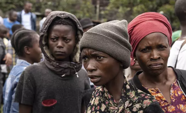 Onlookers gather at the port of Goma, Democratic Republic of Congo, after a ferry carrying hundreds capsized on arrival Thursday, Oct. 3, 2024. (AP Photo/Moses Sawasawa)