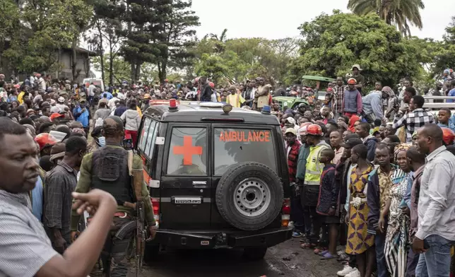 An ambulance carries victims away from the port of Goma, Democratic Republic of Congo, after a ferry carrying hundreds capsized on arrival Thursday, Oct. 3, 2024. (AP Photo/Moses Sawasawa)