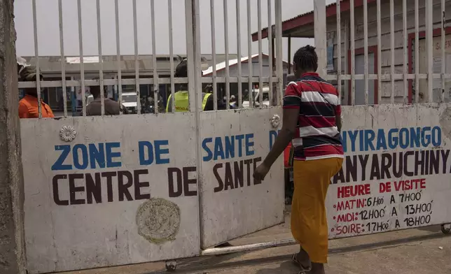 Eveline, 22 , walks to a health center seeking mental counselling in Goma, Democratic republic of the Congo, Monday, Aug. 26, 2024. (AP Photo/Moses Sawasawa)