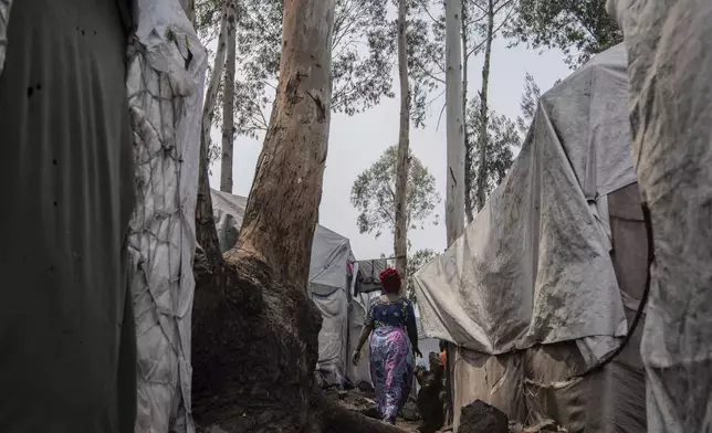 Nelly Shukuru, 51, who had planned hanging herself, walks in the Lushagala camp in Goma, Democratic Republic of the Congo, Tuesday, Aug. 27, 2024. (AP Photo/Moses Sawasawa)