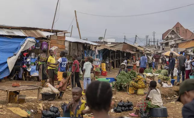 Women sell vegetables Wednesday, Sept. 4, 2024 in Kamituga, eastern Congo. (AP Photo/Moses Sawasawa)