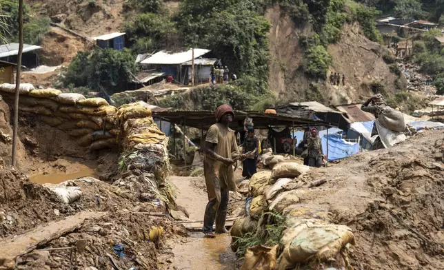 Miners walk Thursday, Sept. 5, 2024 in Kamituga, eastern Congo. (AP Photo/Moses Sawasawa)