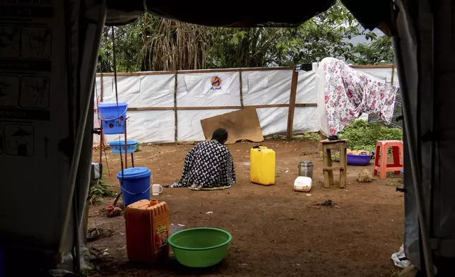 A sex worker suffering from mpox sits in a hospital courtyard Wednesday, Sept. 4, 2024 in Kamituga, eastern Congo. (AP Photo/Moses Sawasawa)