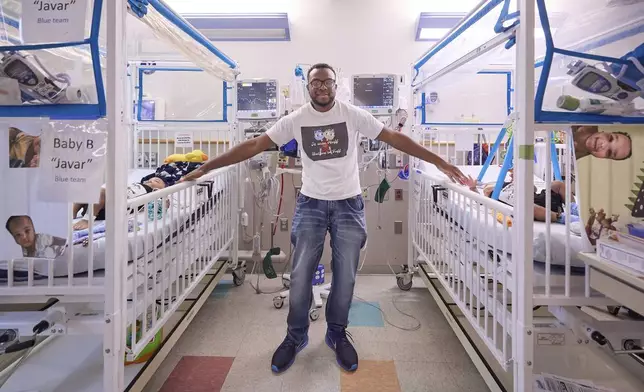 This undated photo provided by the Children’s Hospital of Philadelphia in October 2024 shows Tim Ruffin with his previously conjoined twins, after eparation surgery at the Children’s Hospital of Philadelphia. (Ed Cunicelli/Children’s Hospital of Philadelphia via AP)