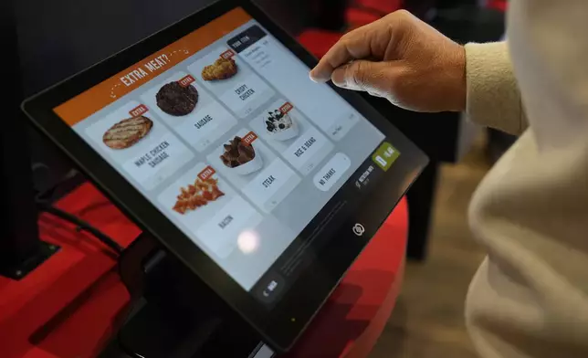 Brian Blair, of Akron, Ohio, enters his food order at a Sheetz convenience store, Thursday, Oct. 17, 2024, in Bethlehem, Pa. (AP Photo/Matt Slocum)