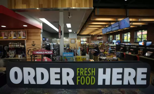 Customers checkout at a Sheetz convenience store, Thursday, Oct. 17, 2024, in Bethlehem, Pa. (AP Photo/Matt Slocum)