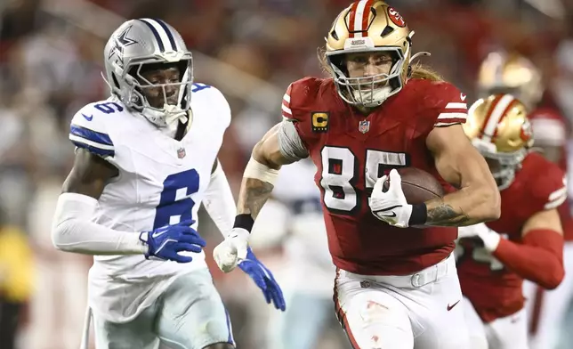 San Francisco 49ers tight end George Kittle (85) runs against Dallas Cowboys safety Donovan Wilson (6) during the second half of an NFL football game in Santa Clara, Calif., Sunday, Oct. 27, 2024. (AP Photo/Eakin Howard)