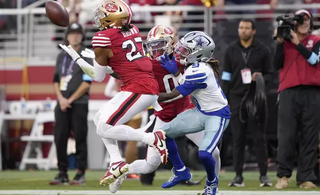 San Francisco 49ers safety Ji'Ayir Brown (27) intercepts a pass intended for Dallas Cowboys wide receiver KaVontae Turpin (9) during the first half of an NFL football game in Santa Clara, Calif., Sunday, Oct. 27, 2024. (AP Photo/Tony Avelar)