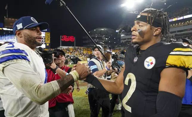 Dallas Cowboys quarterback Dak Prescott, left, talks with Pittsburgh Steelers quarterback Justin Fields following an NFL football game, early Monday, Oct. 7, 2024, in Pittsburgh. The Cowboys won 20-17. (AP Photo/Matt Freed)